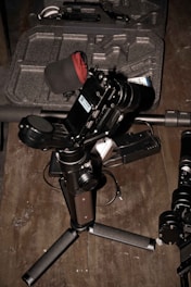 Close-up of a smartphone setup with basic audiovisual equipment on a wooden table.