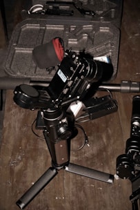 Close-up of a smartphone setup with basic audiovisual equipment on a wooden table.