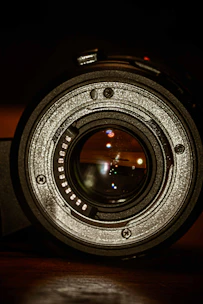 A close-up of a premium portrait lens with intricate detailing and a gold ring.