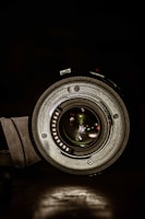 Close-up of a high-end camera lens with detailed focus rings and glass elements.