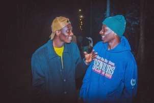 A friendly AI chatbot assisting a customer on a clothing e-commerce website at night.