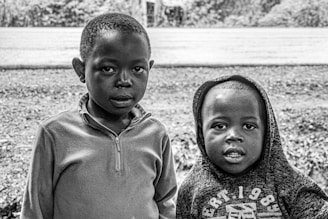 A lifestyle photo of children wearing stylish streetwear while playing outdoors.