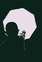 A faint silhouette of a child reaching toward a shimmering, ethereal light in a dim room.