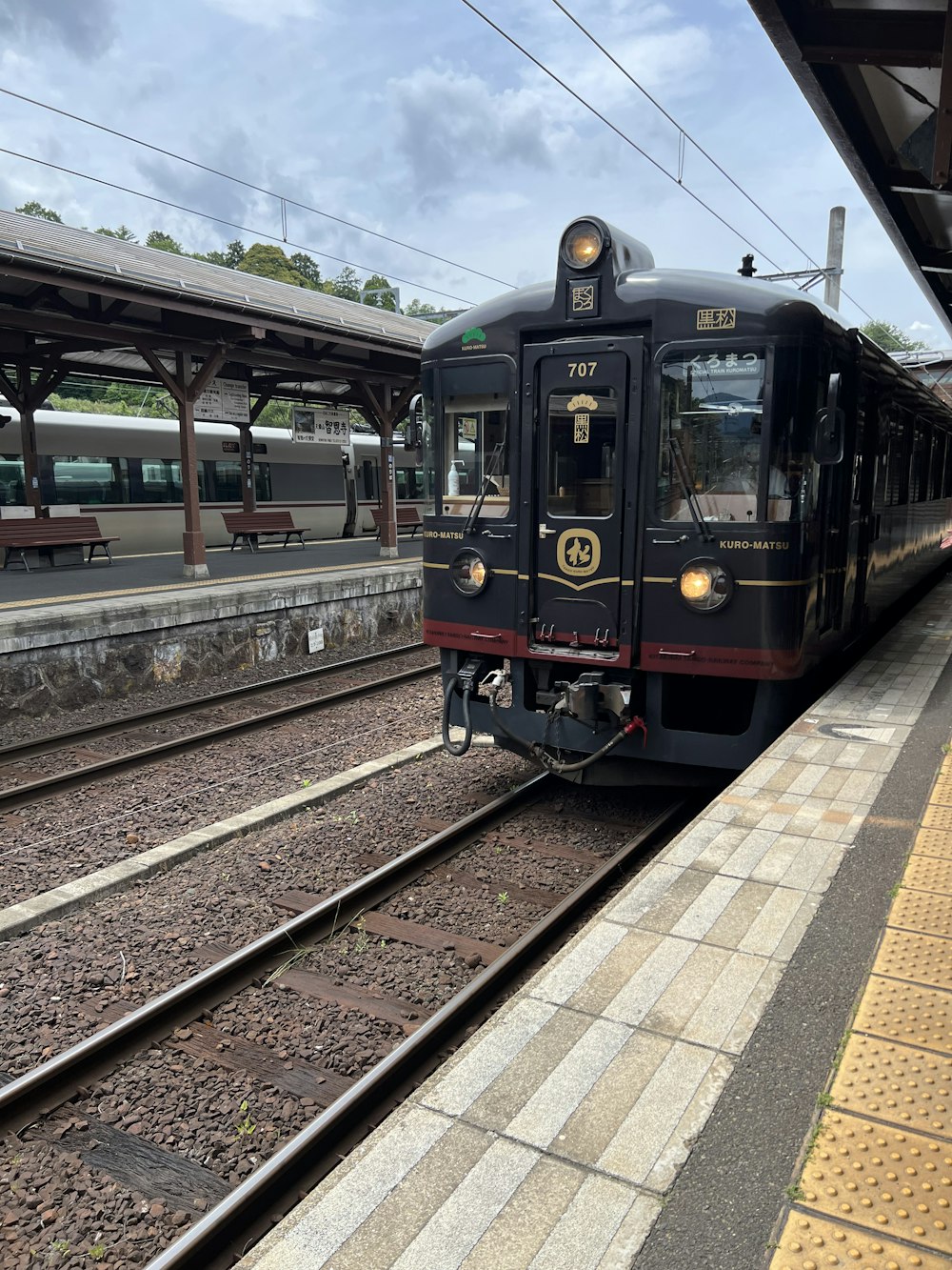 a train pulling into a train station next to a platform