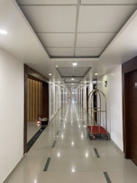 Housekeeping carts stocked with cleaning supplies in a hotel corridor.