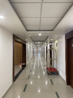 Housekeeping carts stocked with cleaning supplies in a hotel corridor.