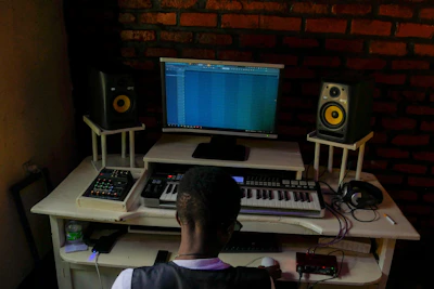 Main workstation featuring Audient ID14 interface and studio master console.