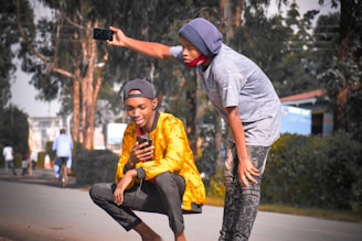 Young students using smartphones to record environmental data in Hanoi's urban streets.