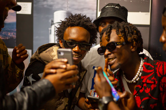 A group of working men engaging with influencer content on their phones, showing real connection.