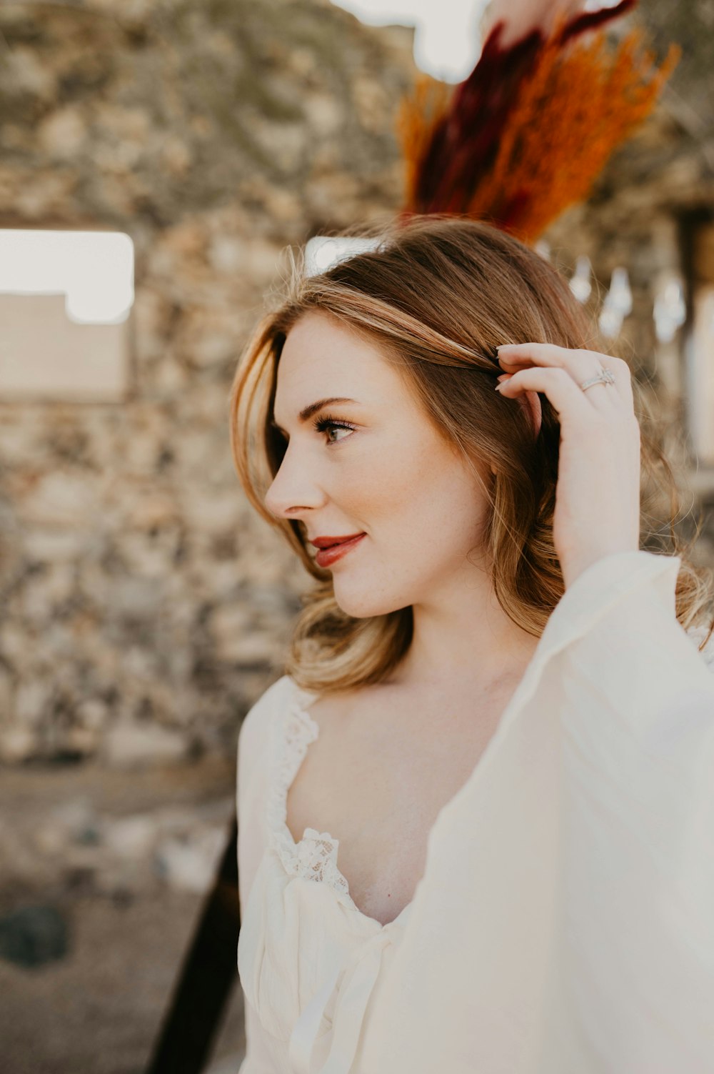 a woman in a white dress posing for a picture