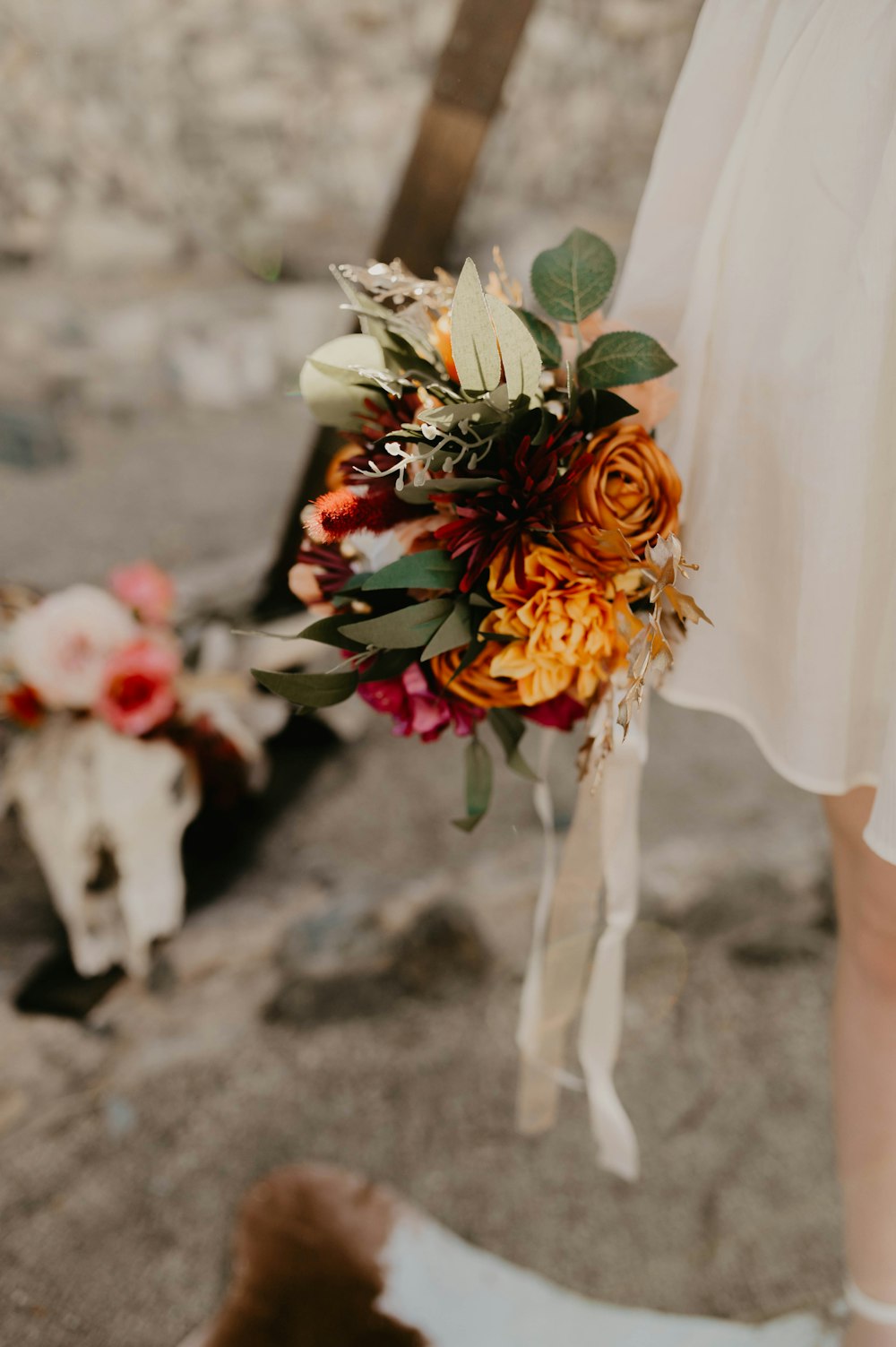 a woman holding a bouquet of flowers in her hand