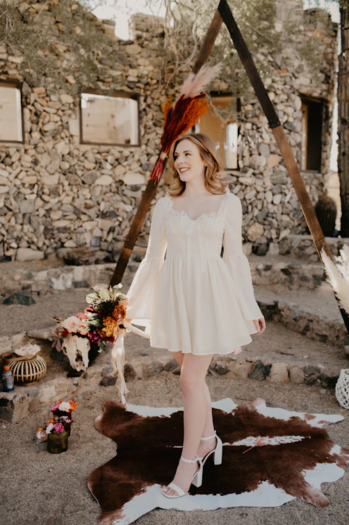 a woman wearing a white dress and a hat