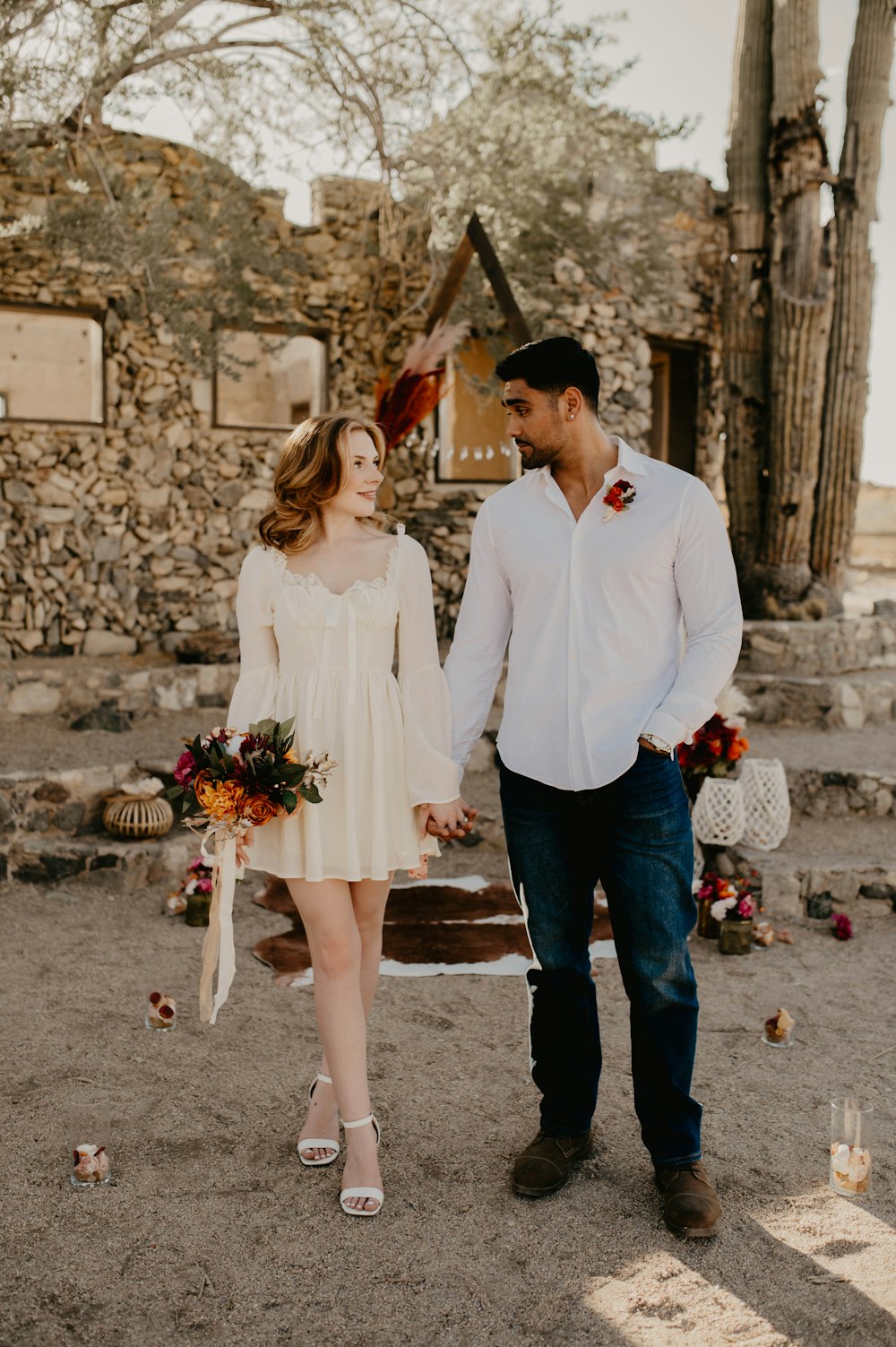 a man and a woman holding hands and walking