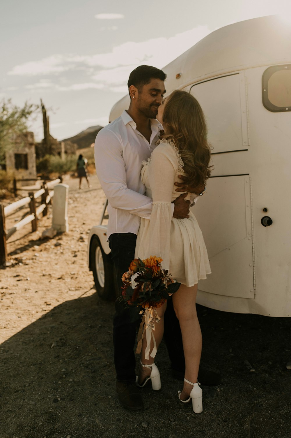 a man and a woman standing in front of a trailer