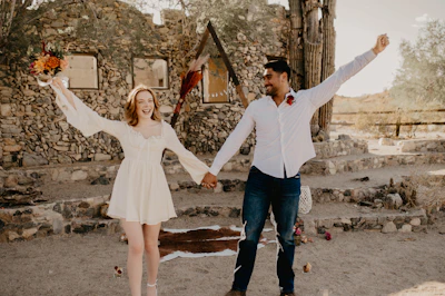 A joyful couple holding hands and smiling during their intimate civil ceremony outdoors