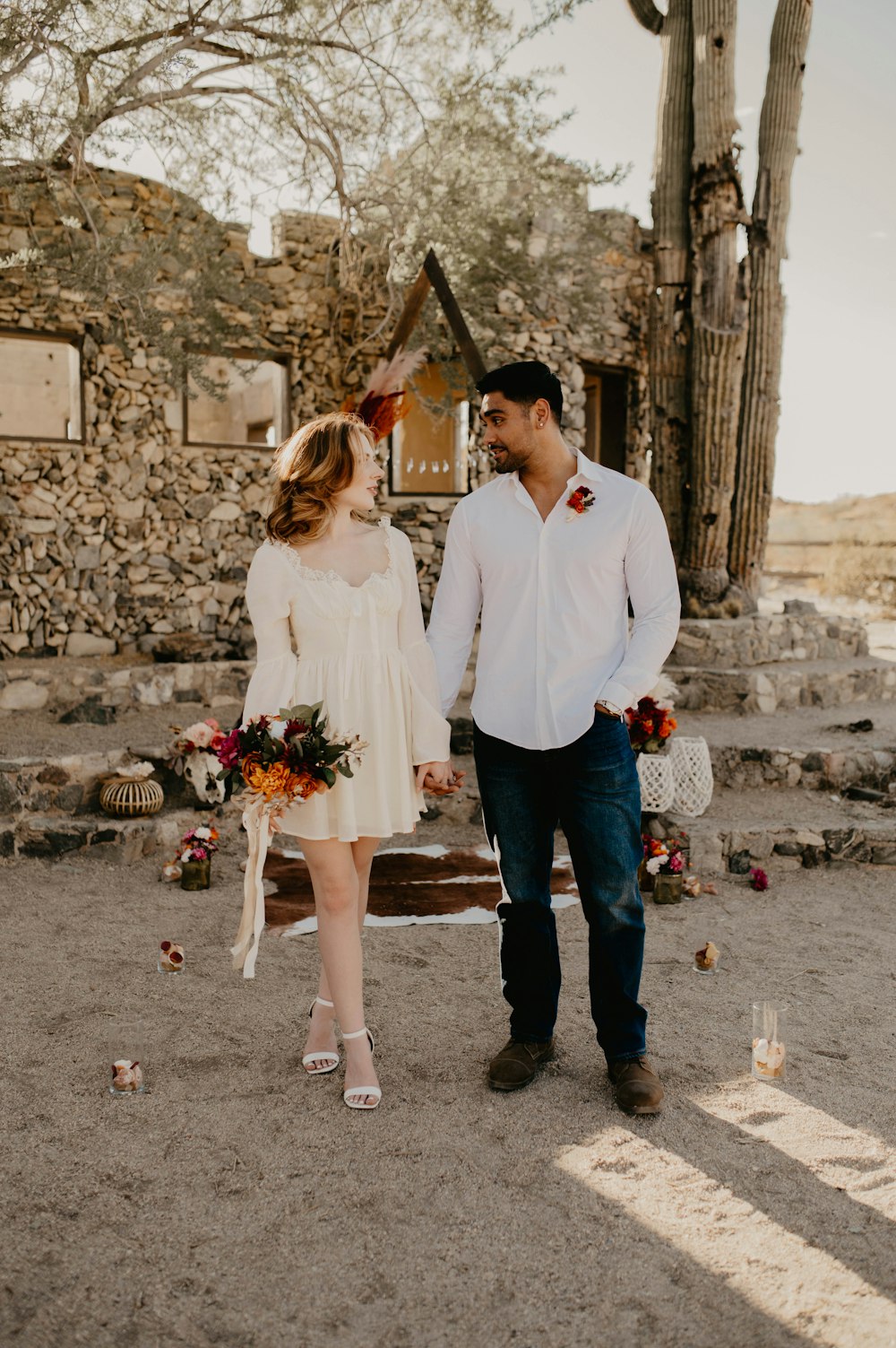 a man and a woman holding hands and walking