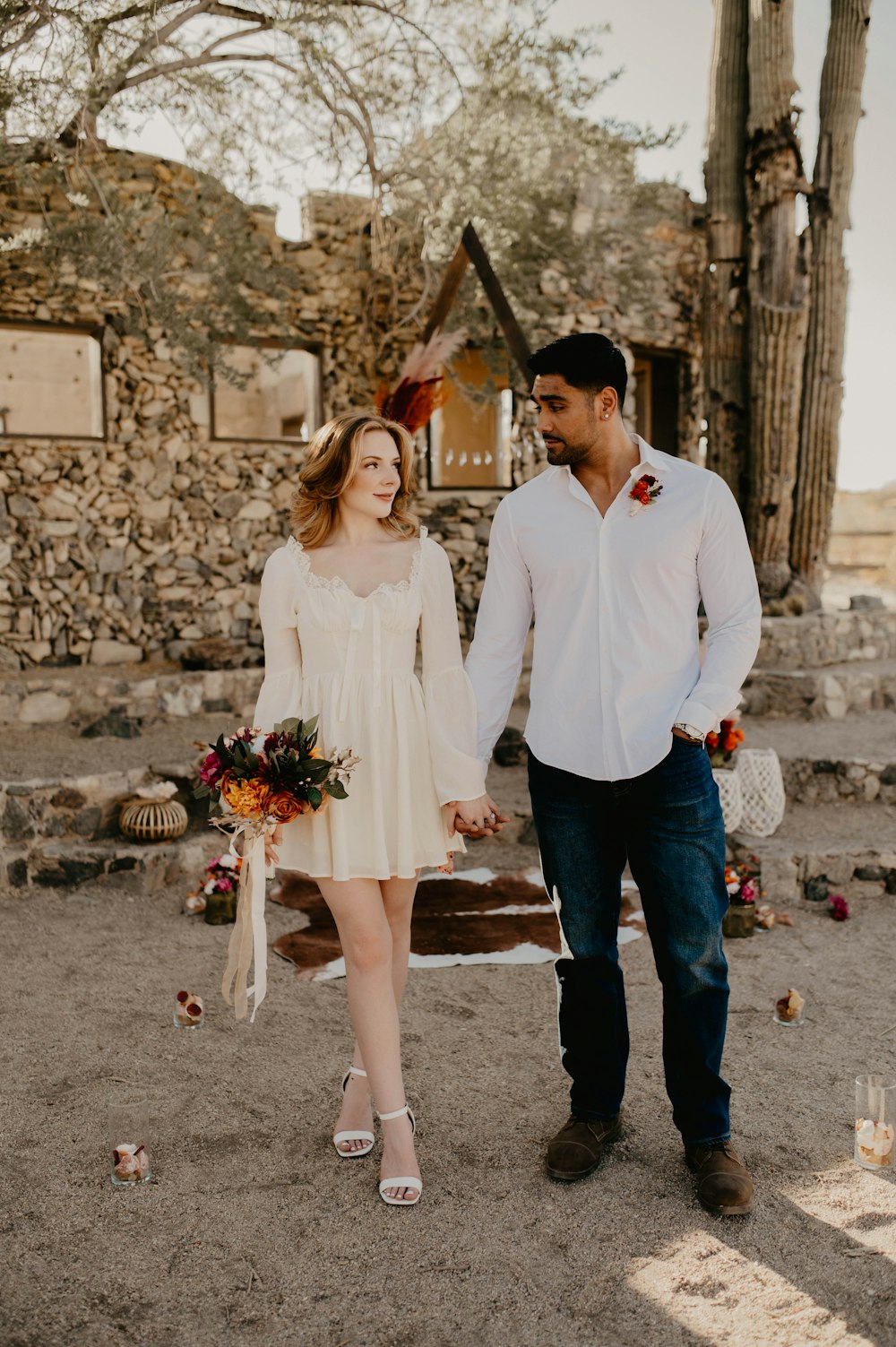 a man and a woman holding hands and walking