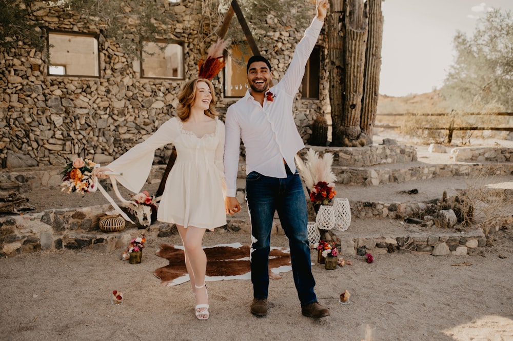 a man and a woman are walking through a desert