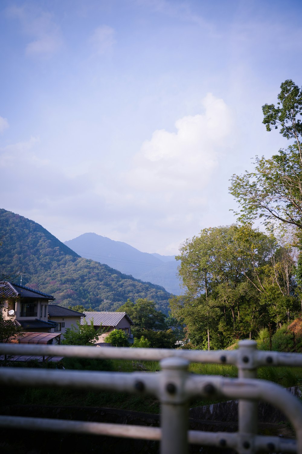 a view of a mountain range from behind a fence