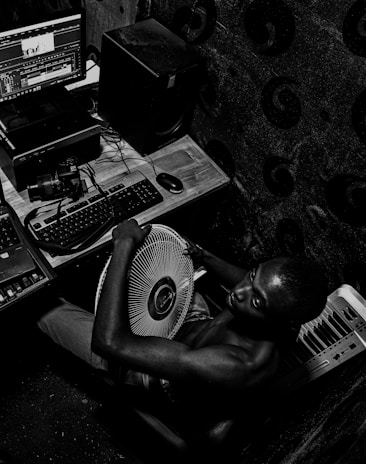 Portrait of Roger Oliveros working on manuscript editing in a cozy studio.