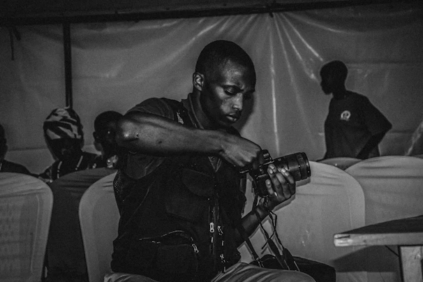 A candid moment during a photo session, with a photographer adjusting lighting equipment.