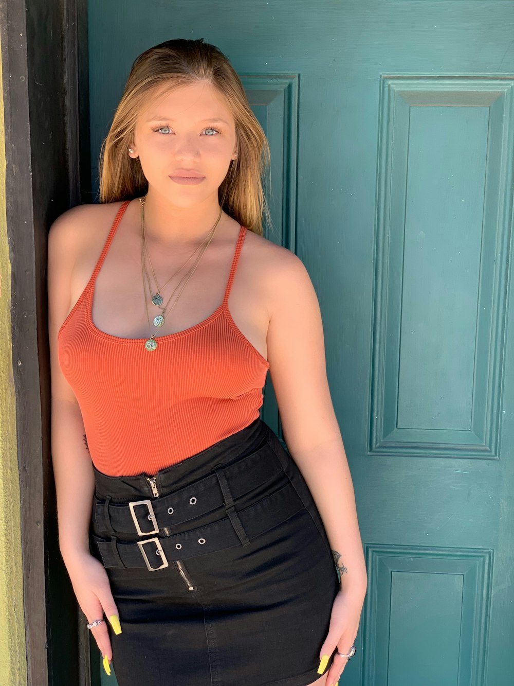 a woman standing in front of a blue door