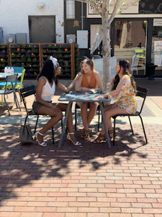 A group of women gathered outdoors in Rutherford County, engaged in a lively discussion.