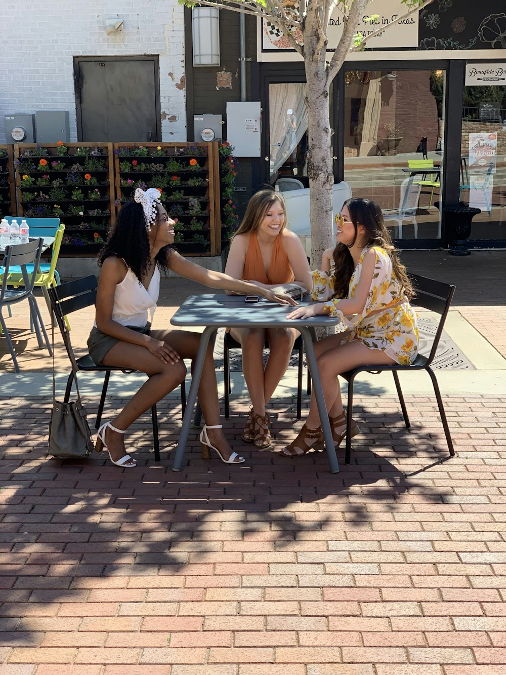 a group of women sitting around a table talking