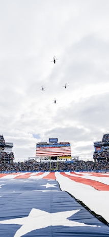 Drone flying over a large football stadium capturing aerial footage for security monitoring.