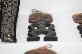 Close-up of traditional Zimbabwean totems carved in wood, symbolizing heritage.
