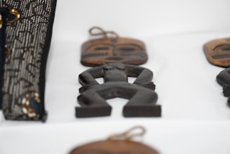 Close-up of small concrete souvenirs with Baltic symbols on a natural linen fabric background.