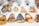 A collection of handcrafted pendants laid out on a white surface. Each pendant features intricate artwork, including animals and abstract designs, with a glossy finish. The artwork is primarily in black and orange tones, and the pendants are teardrop-shaped with varying sizes.