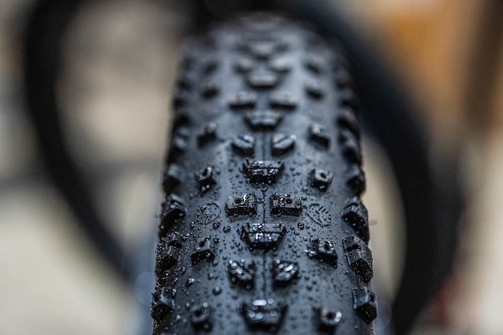 a close up of a bike tire with drops of water on it