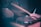 A close-up of hands playing a drum set in a cozy classroom.