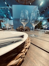 Close-up of a meticulously arranged table setting featuring fine china and crystal glassware.