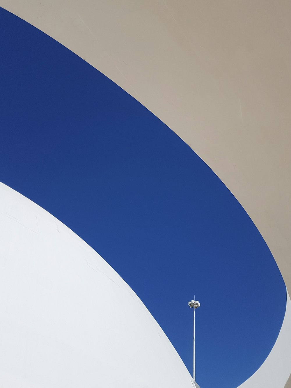 a white and blue building with a street light