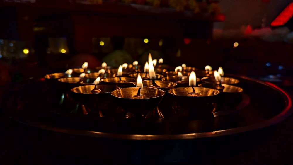 a group of lit candles sitting on top of a table