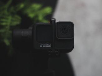 Close-up of a rugged GoPro camera mounted on a mountain bike handlebar, ready for action.