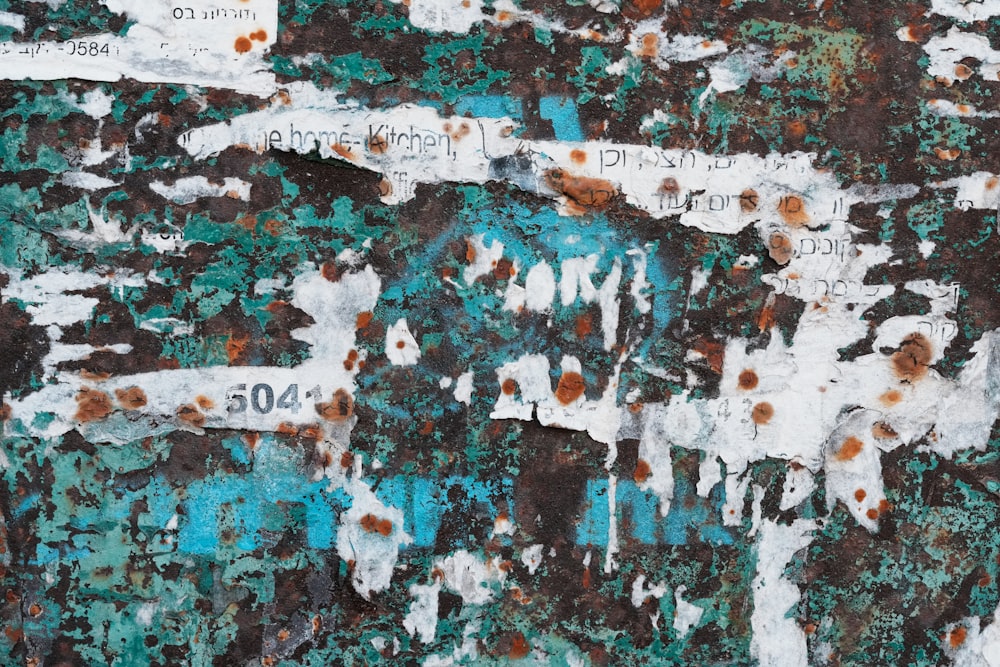 a close up of a wall with peeling paint