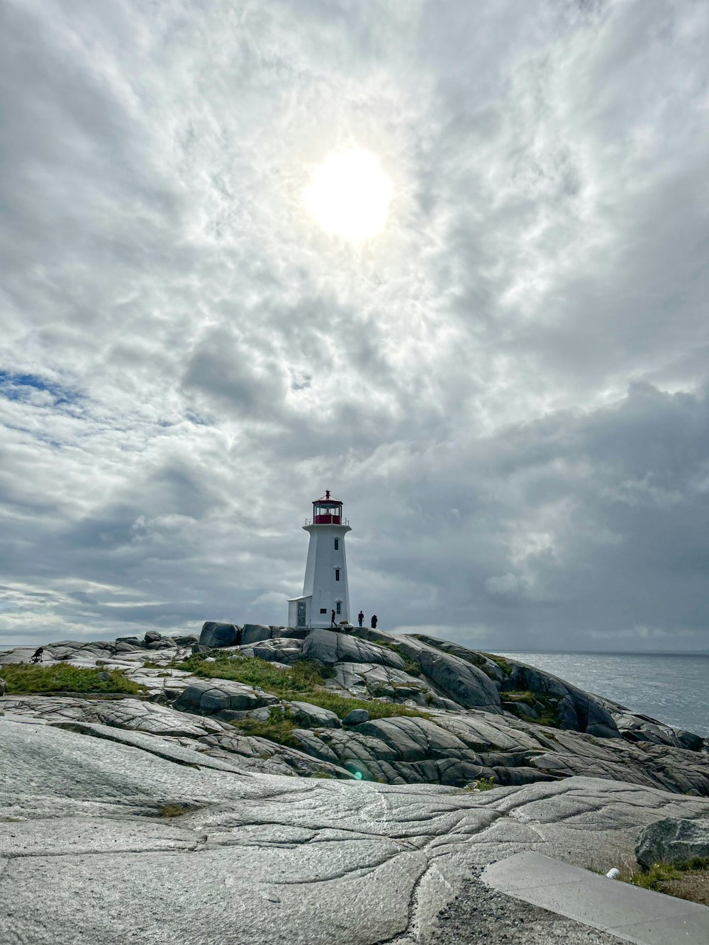 a light house sitting on top of a rocky island