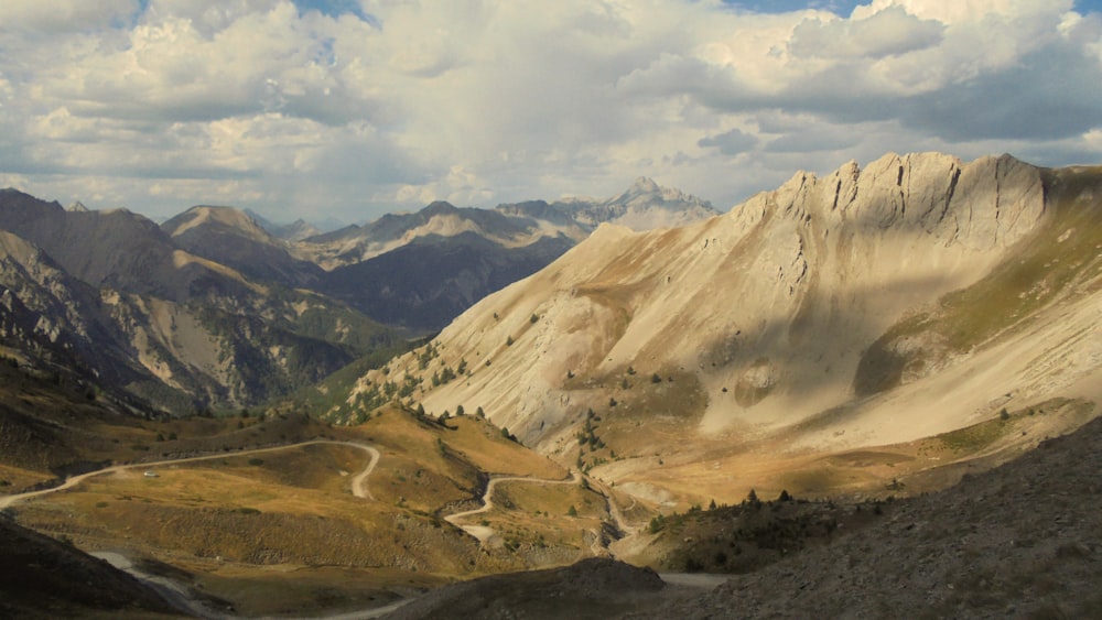 a scenic view of a winding road in the mountains