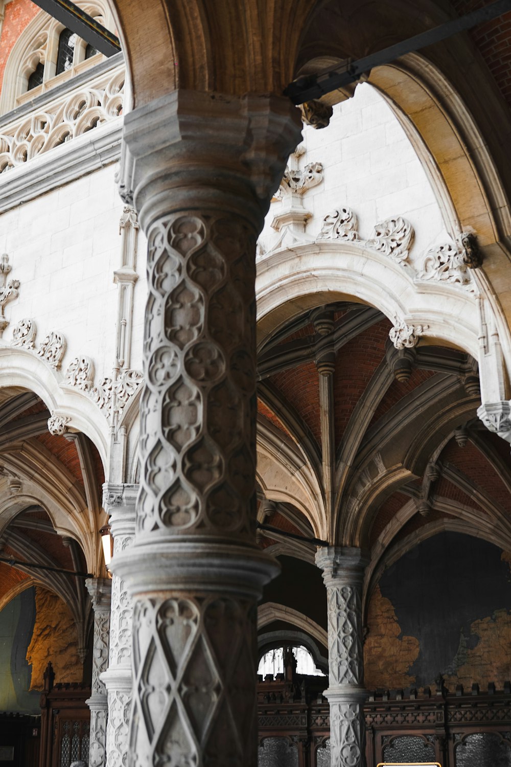 a large pillar in a building with a clock on it