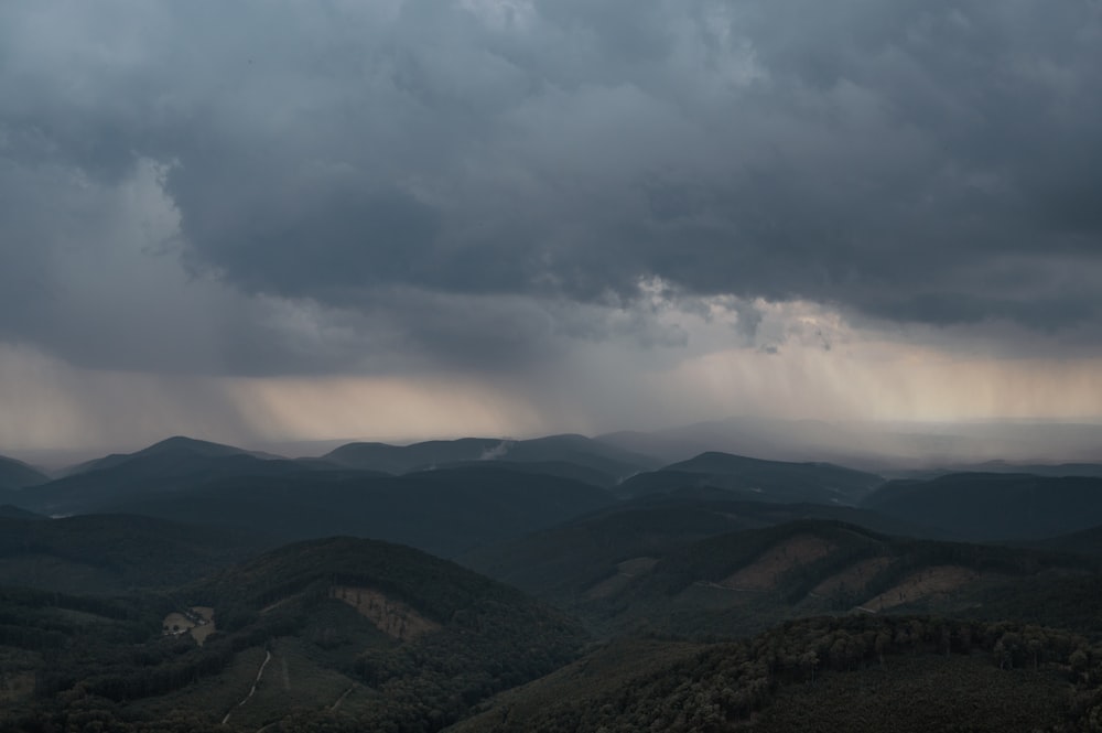 a view of a mountain range under a cloudy sky