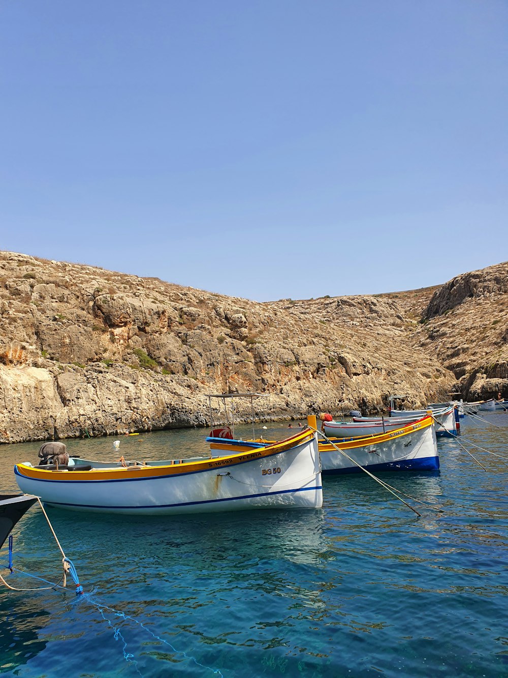 a couple of boats floating on top of a body of water