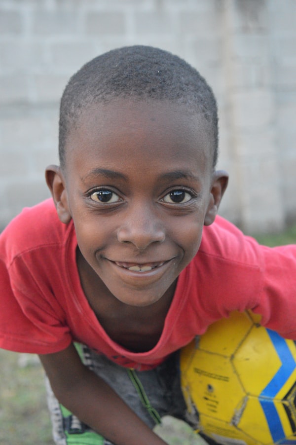 Youth soccer keeper looking at the camera with a colorful ball