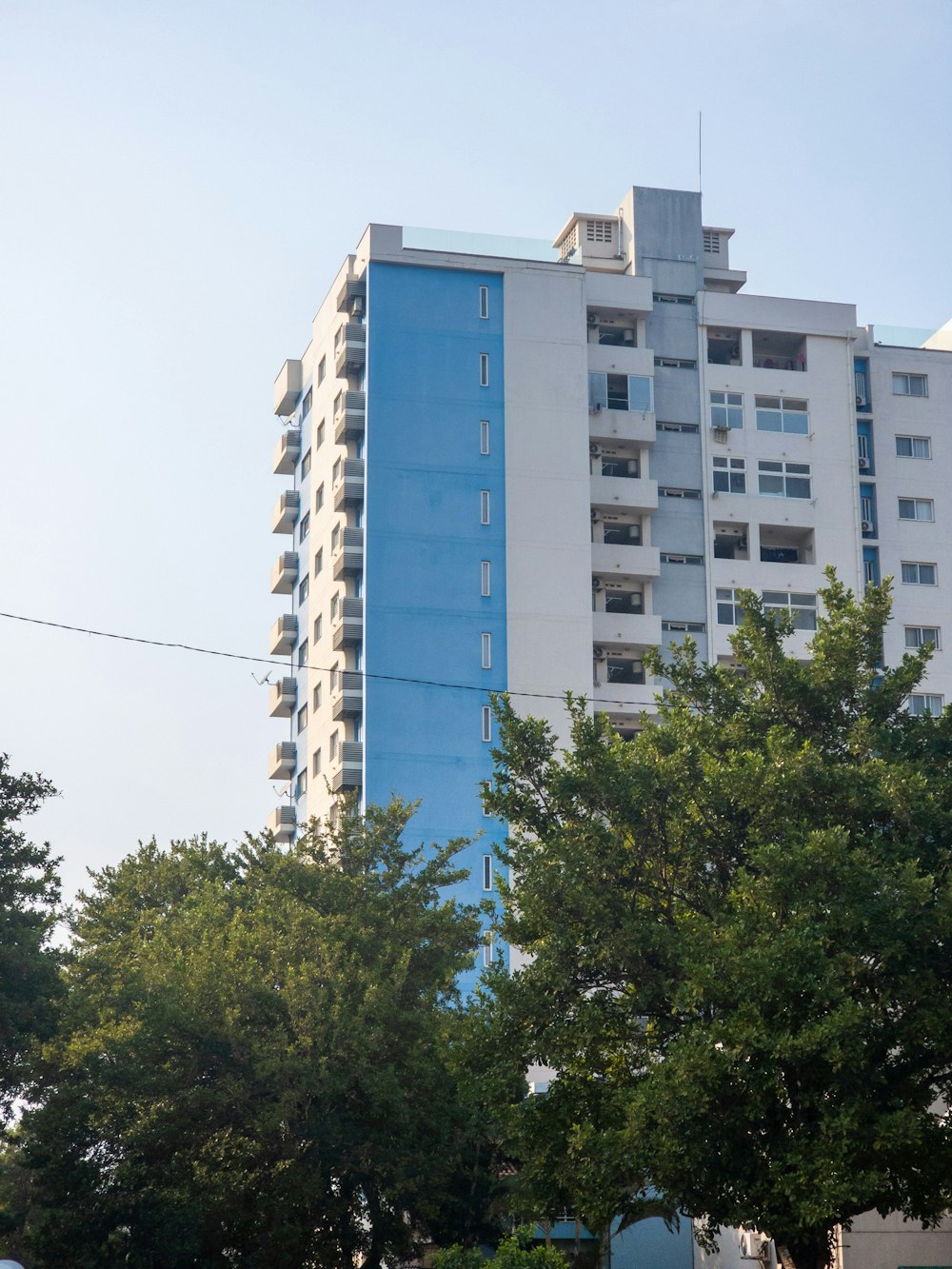 a blue and white building with trees in front of it