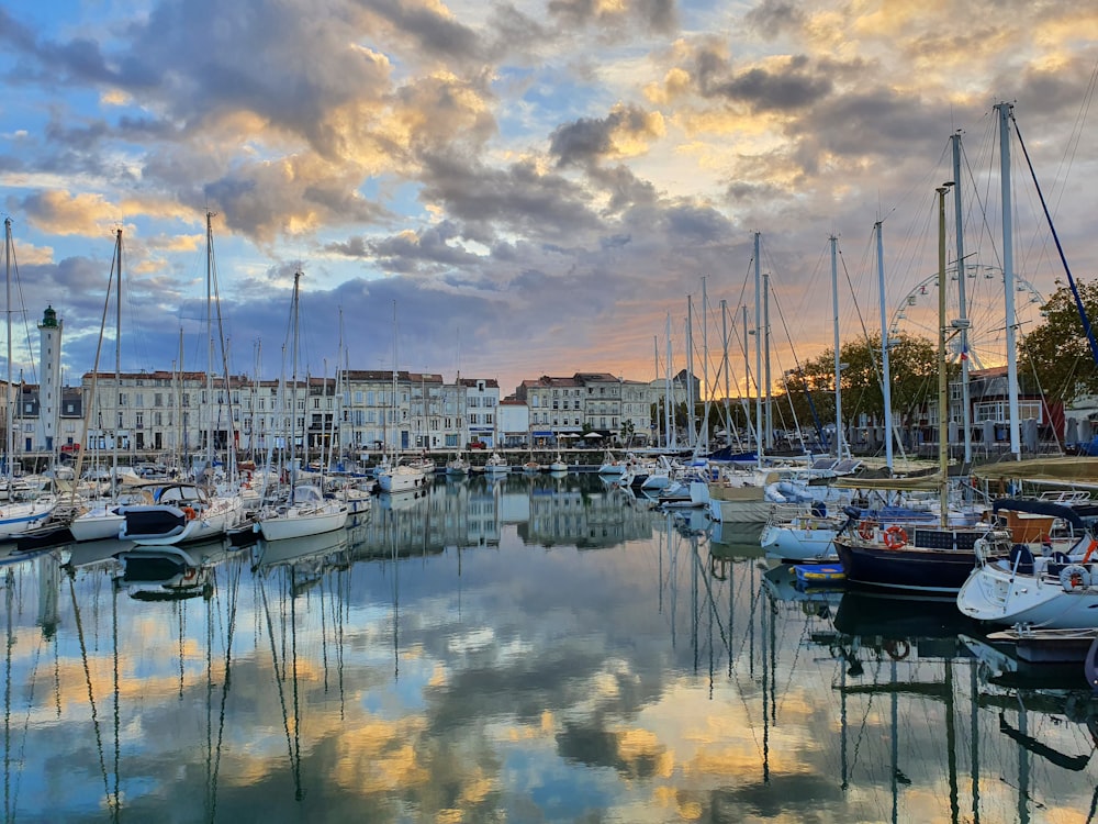 a harbor filled with lots of boats under a cloudy sky