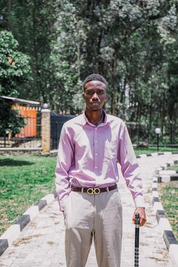 A person wearing the sleek posture-correcting wearable while walking in a sunlit park.