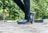 Close-up of a person walking on a paved path wearing comfortable shoes.