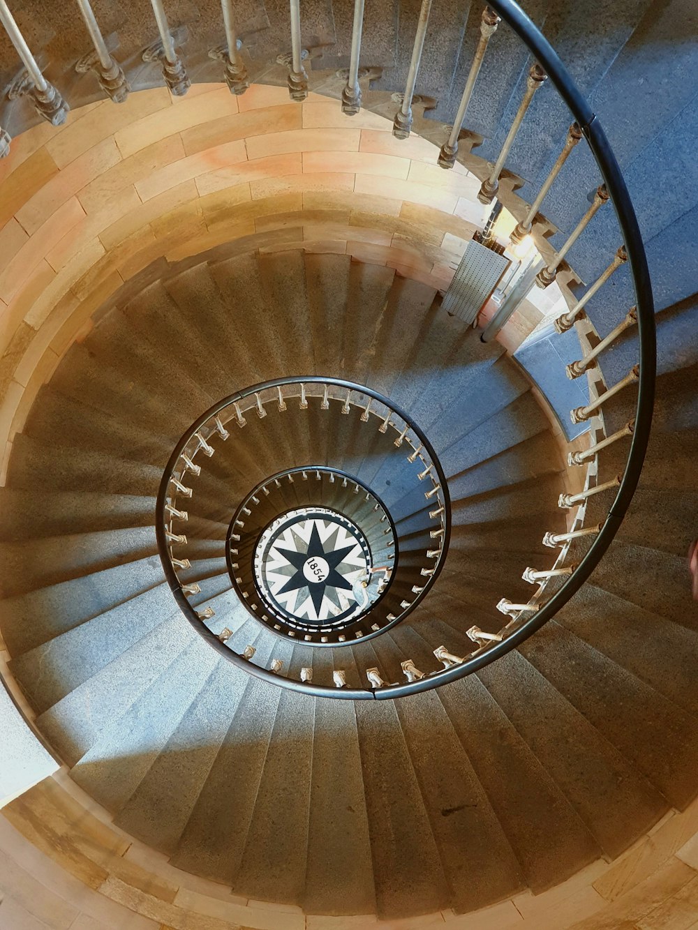 a spiral staircase in a building with a clock on it